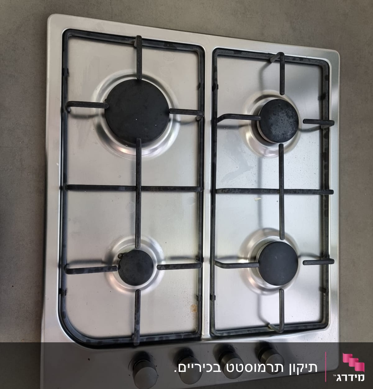 כיריים גז עם ארבעה מבערים וכפתורי שליטה